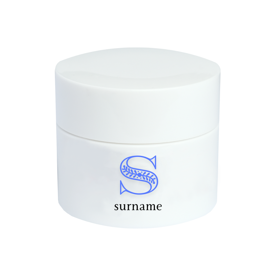 A white cosmetic jar with a minimalist design, featuring a decorative blue letter "S" above the word "surname" on the front