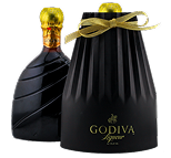 A bottle of GODIVA liqueur with a gold foil top, accompanied by a black, pleated gift container tied with a gold ribbon and branded with the GODIVA logo