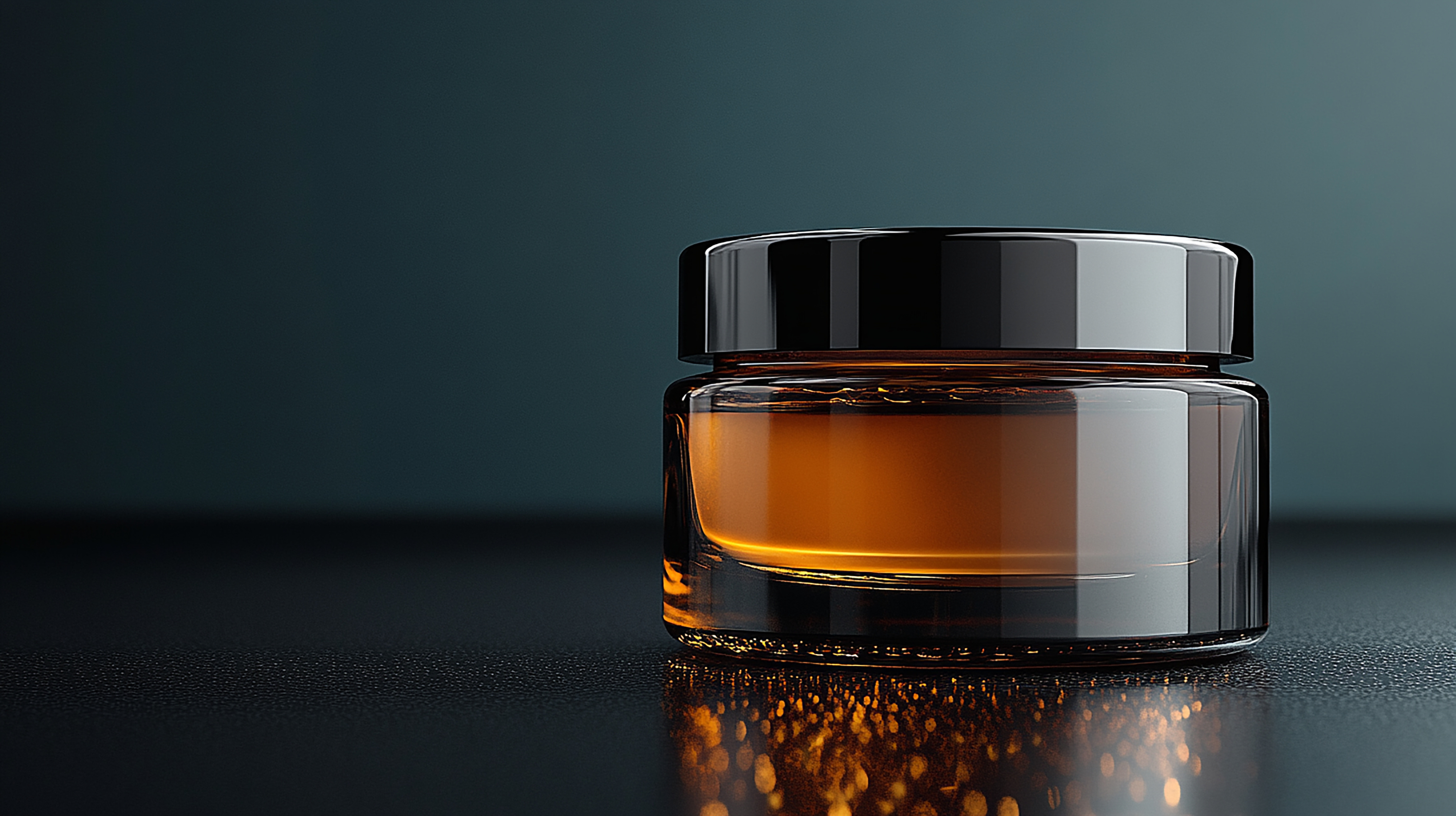 A sleek amber glass jar with a glossy black lid, filled with a rich amber-colored cosmetic cream or serum, placed on a dark reflective surface with moody lighting