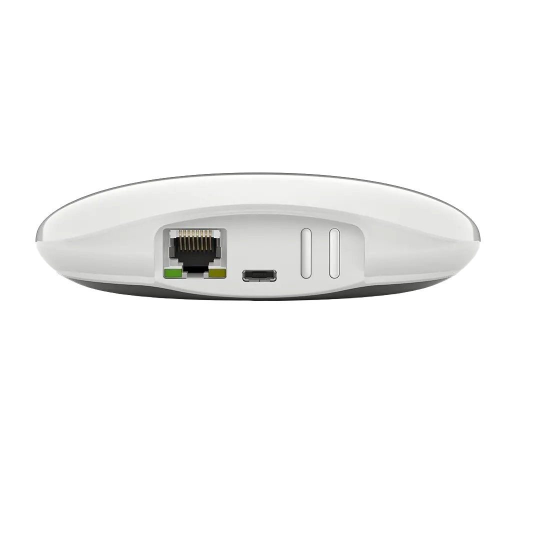 A close-up view of the bottom of a sleek white electronic device showing an Ethernet port, a USB-C port, and two small slots
