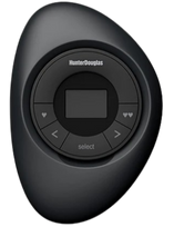 A sleek black Hunter Douglas remote control with a circular interface, arrow buttons, and a small central screen for operating window treatments