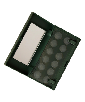 Open dark green rectangular case containing a white rectangular block on the left side and a clear plastic insert on the right side with circular slots, likely designed to hold small round items such as coins or samples
